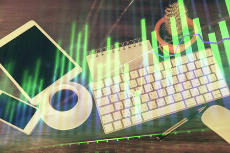 Double exposure of forex chart hologram over desktop with phone. Top view. Mobile trade platform concept.の写真素材