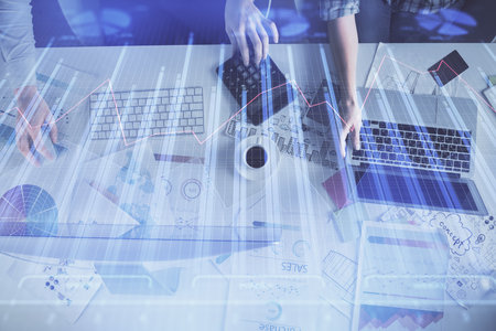 Multi exposure of man and woman working together and financial chart hologram. Business concept. Computer background.の写真素材