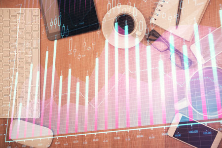 Double exposure of financial chart hologram over desktop with phone. Top view. Mobile trade platform concept.の写真素材