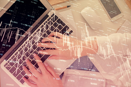 Double exposure of woman hands working on computer and forex chart hologram drawing. Top View....