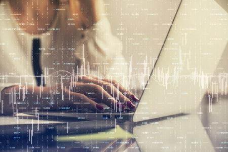 Multi exposure of woman hands typing on computer and financial graph hologram drawing. Stock market...