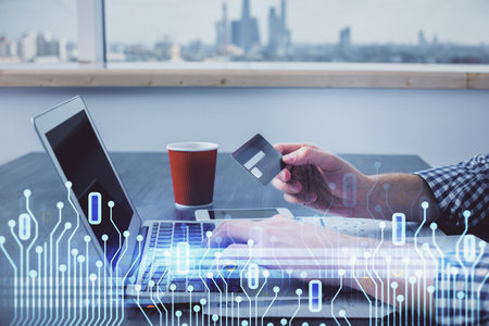 Double exposure of man hands holding a credit card and data theme drawing. E-commerce and technology concept.の写真素材