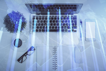 Multi exposure of forex chart drawing over table background with computer. Concept of financial...
