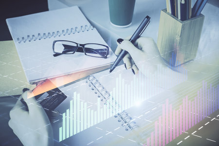 Multi exposure of woman on-line shopping holding a credit card and financial graph drawing. Stock market E-commerce concept.の写真素材