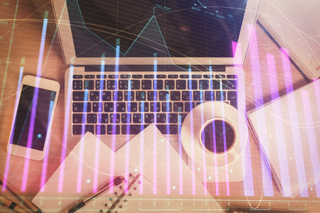 Stock market chart and top view computer on the table background. Double exposure. Concept of financial analysis.の写真素材