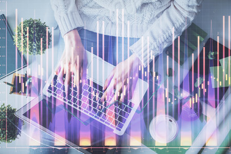 Double exposure of woman hands working on computer and forex chart hologram drawing. Top View. Financial analysis concept.の写真素材