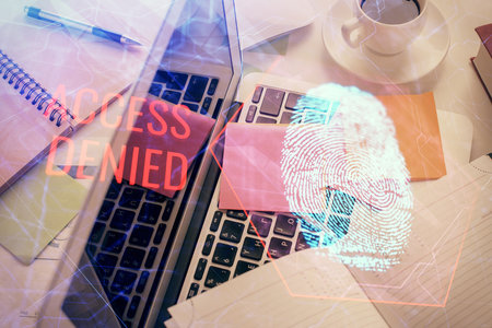 Finger print over computer on the desktop background. Top view. Double exposure. Concept of securitization.の写真素材