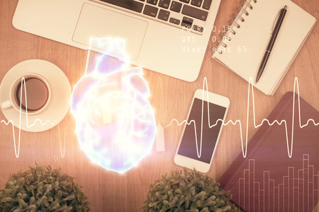 Double exposure of heart drawing over table with phone. Top view. Medical education concept.の写真素材