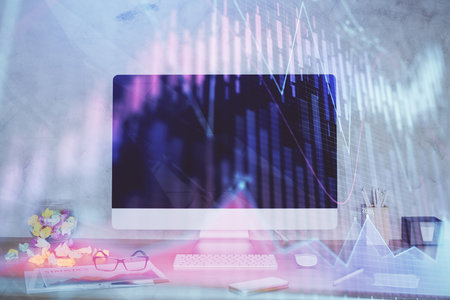 Forex graph hologram on table with computer background. Double exposure. Concept of financial markets.の写真素材