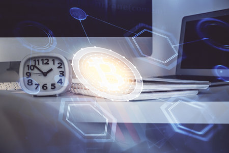 Multi exposure of blockchain theme hologram and table with computer background. Concept of bitcoin crypto currency.の写真素材