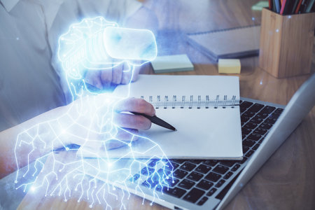 AR hologram over woman's hands taking notes background. Concept of augmented reality. Multi exposureの写真素材
