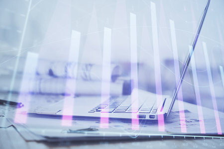 Forex graph hologram on table with computer background. Multi exposure. Concept of financial markets.の写真素材