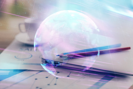 Computer on desktop in office with technology theme hologram. Double exposure. Tech concept.の写真素材