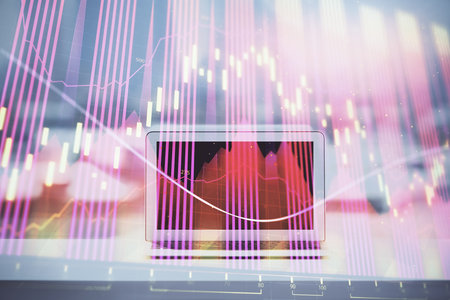 Forex graph hologram on table with computer background. Multi exposure. Concept of financial markets.の写真素材