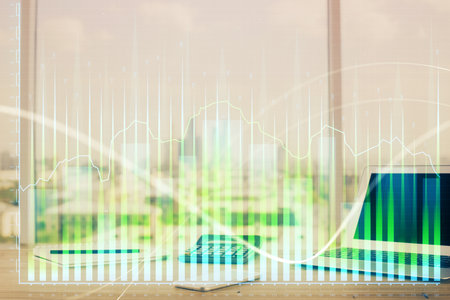 Forex graph hologram on table with computer background. Multi exposure. Concept of financial markets.の写真素材