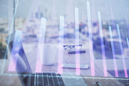 Forex graph hologram on table with computer background. Multi exposure. Concept of financial markets.の写真素材