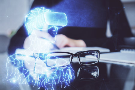 AR hologram over woman's hands taking notes background. Concept of augmented reality. Multi exposureの写真素材