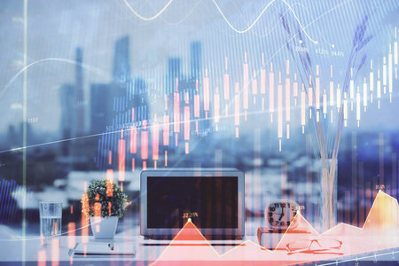Stock market graph on background with desk and personal computer. Double exposure. Concept of financial analysis.の写真素材