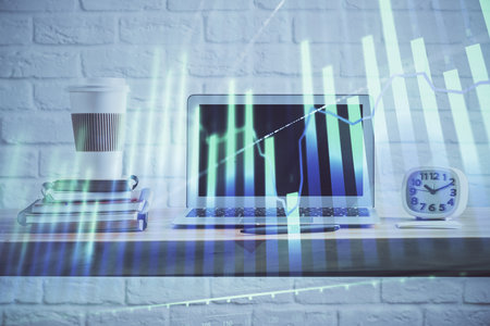 Stock market graph and table with computer background. Double exposure. Concept of financial analysis.の写真素材