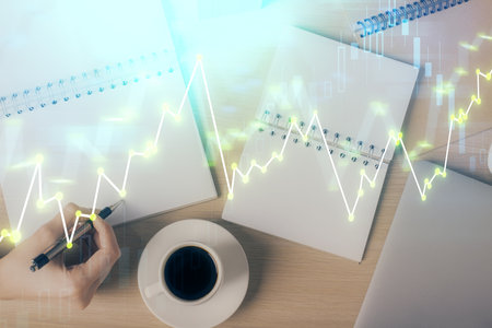 Multi exposure of woman's hands making notes with forex graph hologram. Concept of technical analysis.の写真素材