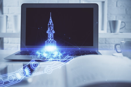 Desktop computer background in office and start up theme hologram drawing. Double exposure. Startup concept.の写真素材