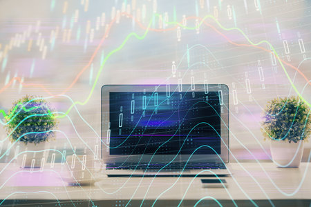 Stock market graph on background with desk and personal computer. Double exposure. Concept of financial analysis.の写真素材