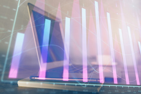 Stock market graph on background with desk and personal computer. Multi exposure. Concept of financial analysis.の写真素材