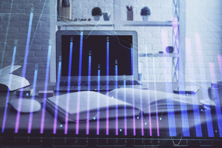 Stock market graph on background with desk and personal computer. Multi exposure. Concept of financial analysis.の写真素材