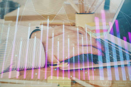 Multi exposure of stock market graph with man working on laptop on background. Concept of financial analysis.の写真素材