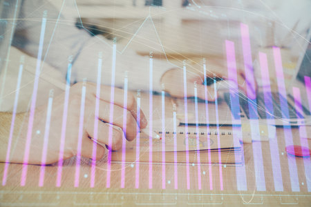 Multi exposure of financial graph with man works in office on background. Concept of analysis.の写真素材