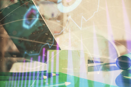 Forex market graph hologram and personal computer on background. Double exposure. Concept of investment.の写真素材