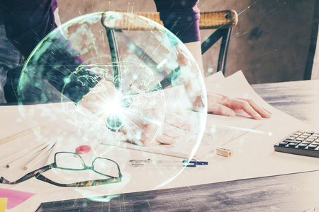 Double exposure of Man writing in notepad with business icons on background. Concept of international business.の写真素材