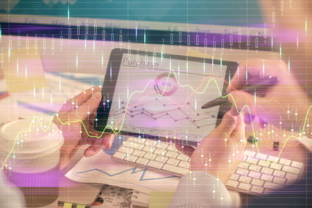 Double exposure of man's hands holding and using a phone and financial chart drawing. Market analysis concept.の写真素材