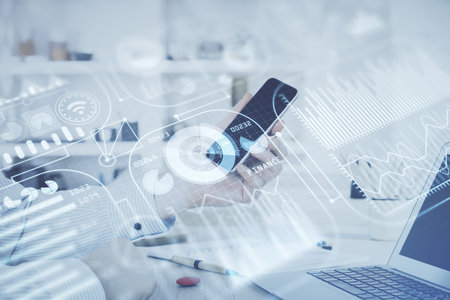 Double exposure of man's hands holding and using a digital device and tech theme hologram drawing. Technology concept.の写真素材