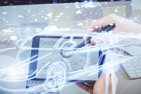Double exposure of man's hands holding and using a digital device and automobile theme hologram drawing. Technology concept.の写真素材