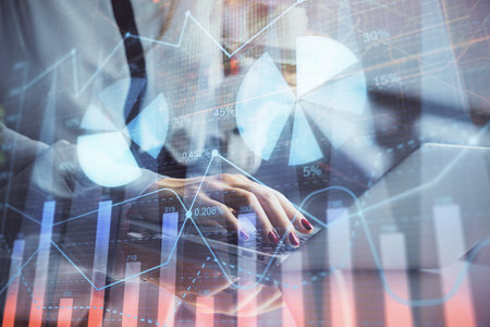 Double exposure of businesswoman hands typing on computer and financial graph hologram drawing. Stock market analysis concept.の写真素材