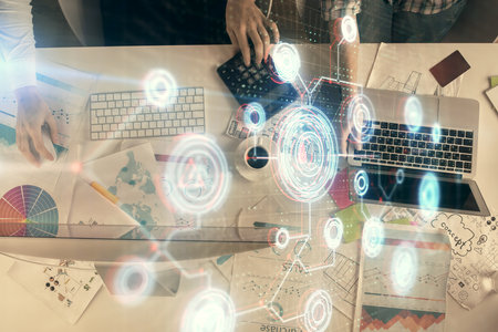 Double exposure of man and woman working together and technology theme drawing hologram. Big data concept. Computer background.の写真素材