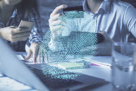 Double exposure of man and woman on-line shopping holding a credit card and fingerprint hologram...