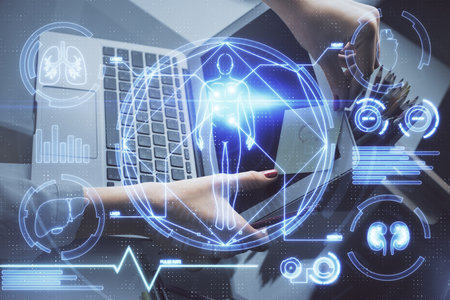 Double exposure of woman hands typing on computer and general theme hologram drawing. Education concept.の写真素材