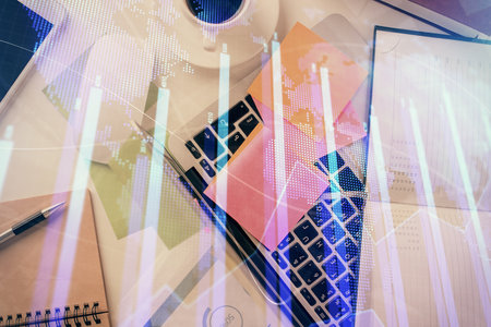 Multi exposure of financial chart drawing over table background with computer. Concept of research and analysis. Top view.の写真素材