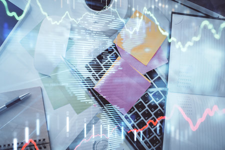 Multi exposure of financial chart drawing over table background with computer. Concept of research and analysis. Top view.の写真素材