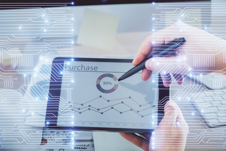 Double exposure of man's hands holding and using a digital device and tech theme hologram drawing. Technology concept.の写真素材