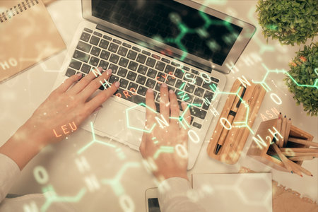 Double exposure of woman hands working on computer and formula hologram drawing. Top View. Science concept.の写真素材