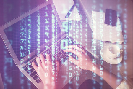 Double exposure of woman hands working on computer and data theme hologram drawing. Tech concept.の写真素材