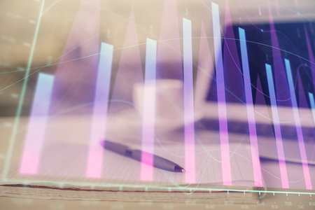 Double exposure of financial graph drawings and desk with open notebook background. Concept of forex marketの写真素材