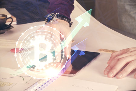 Double exposure of man's hands holding and using a phone and crypto currency blockchain theme drawing.の写真素材