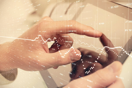 Multi exposure of man's hands holding and using a phone and financial chart drawing. Market analysis concept.の写真素材