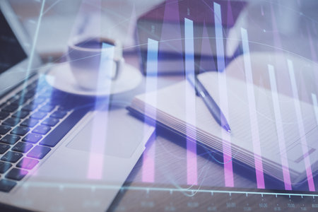 Double exposure of forex chart drawing and desktop with coffee and items on table background. Concept of financial market tradingの写真素材