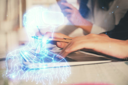 Double exposure of woman hands typing on computer and man in AR glasses drawing. Education concept.の写真素材