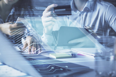 Double exposure of man and woman on-line shopping holding a credit card and data theme hologram drawing. Ai and E-commerce pay on-line concept.の写真素材